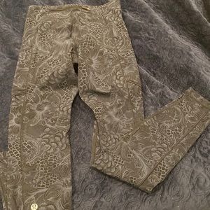 Lululemon leggings black background with subtle blue floral print